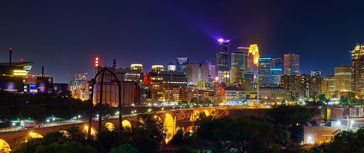 Skyline view of Minneapolis at night by the Mississippi river in Saint Anthony Main